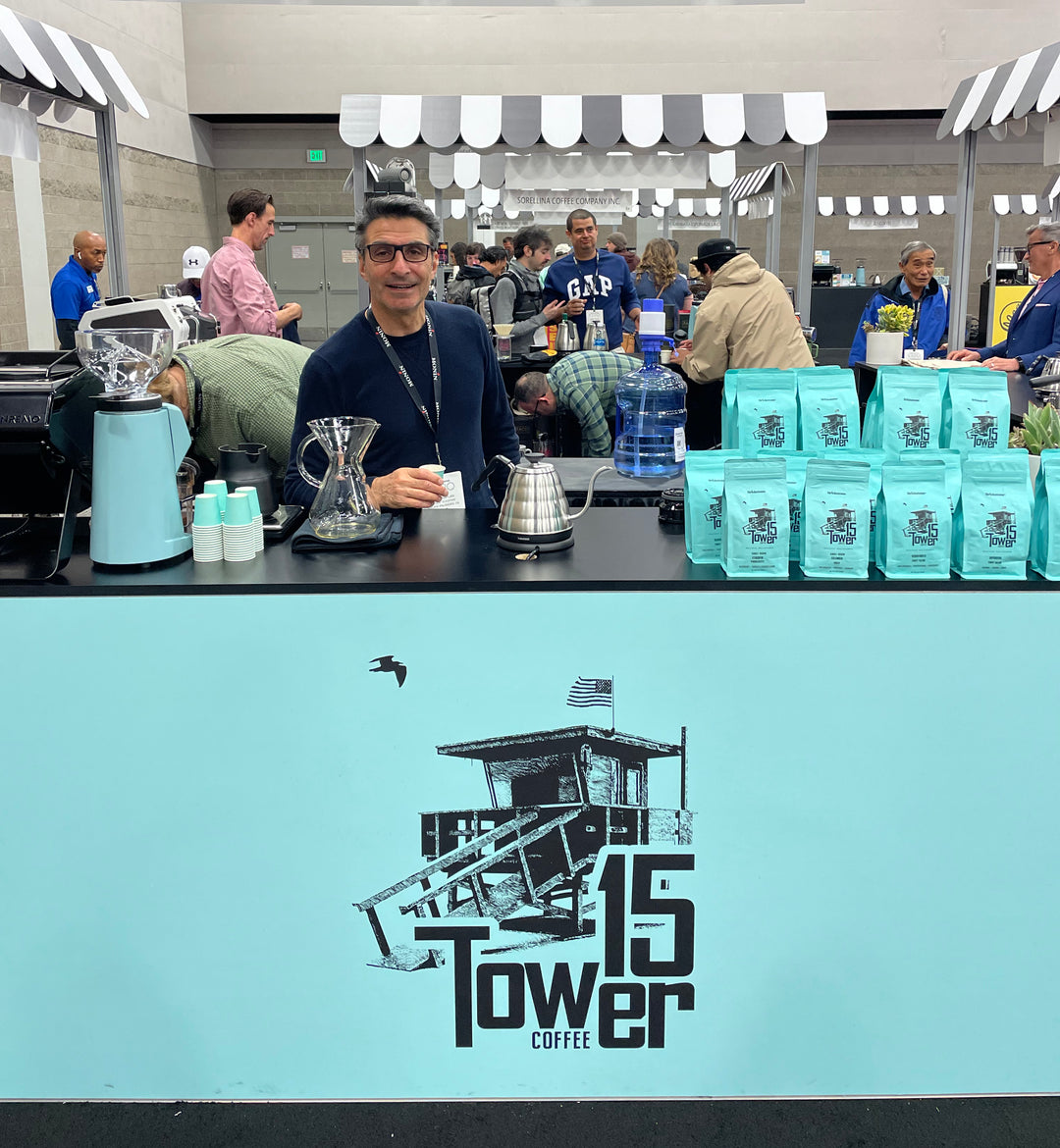 Owner Isaac Kaplan smiling and standing behind Tower 15 Coffee table showcasing product