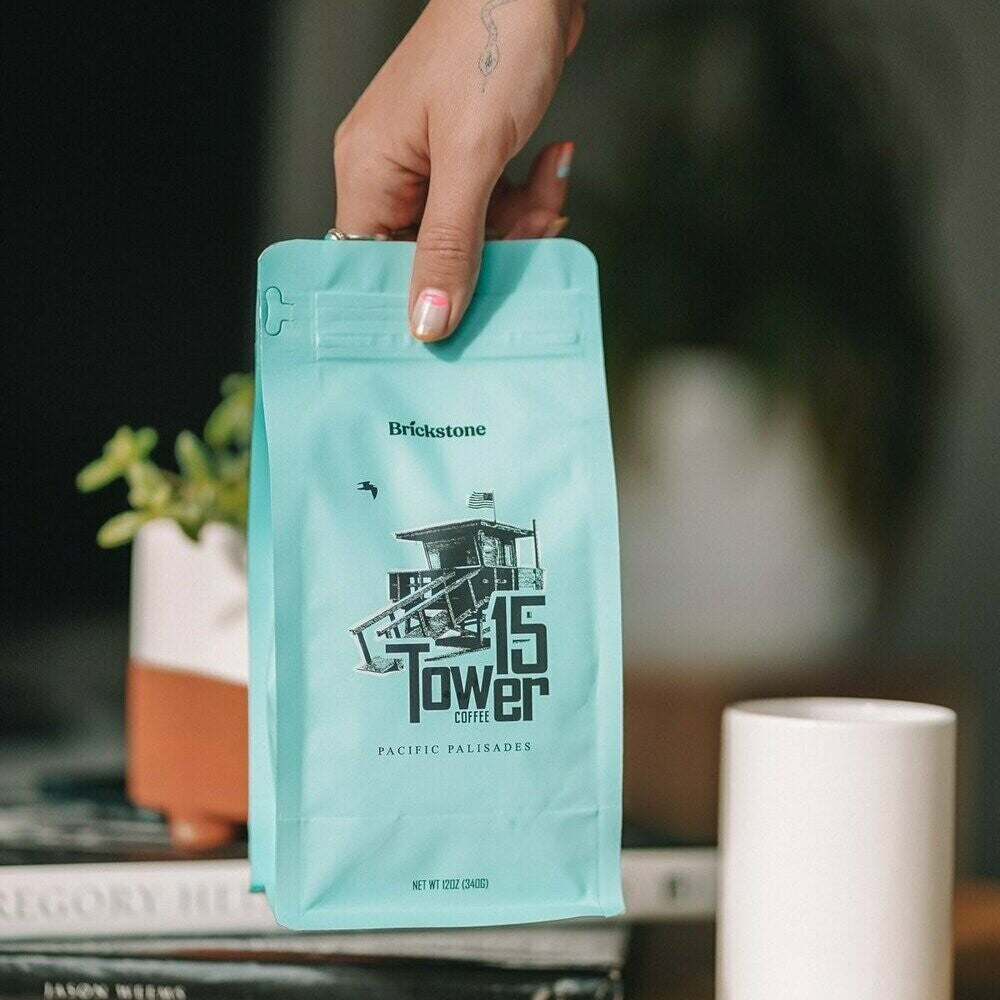 hand holding a bag of tower 15 coffee